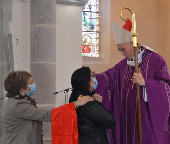 Chrismation d'Élodie accompagnée de sa marraine, par l'évêque Monseigneur Sylvain Bataille